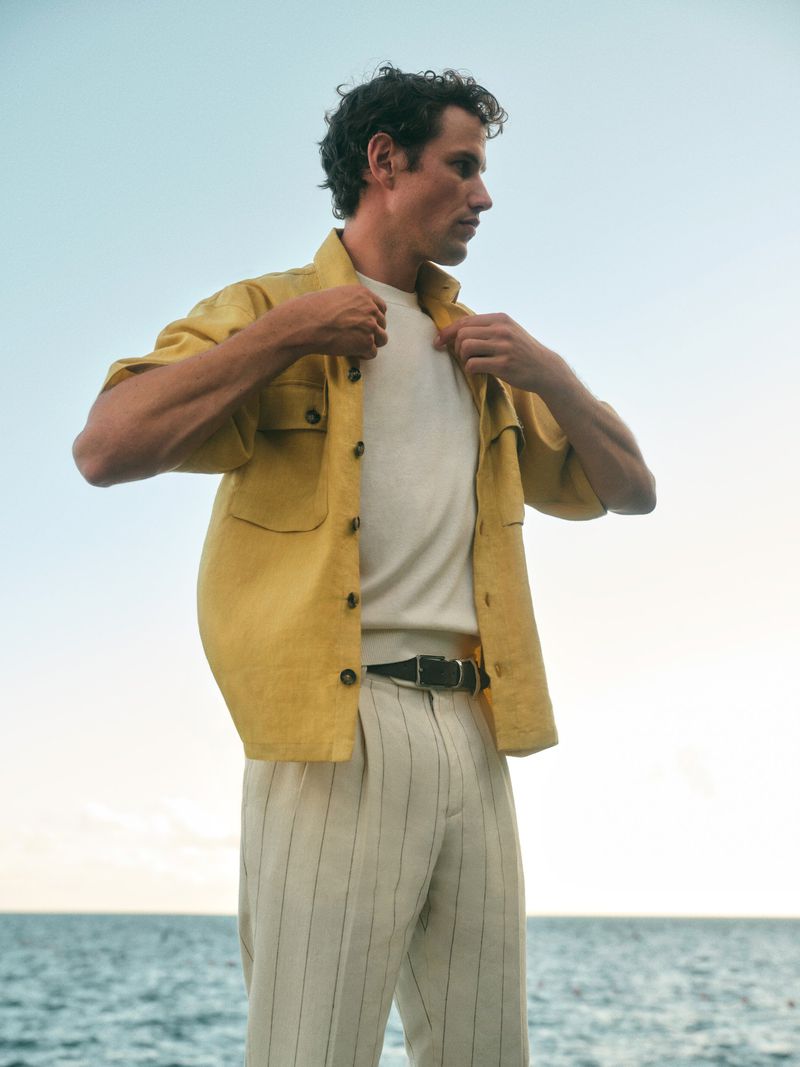 Model Paul Hupfer wearing yellow linen overshirt against the sea for Windsor SS 2025 campaign photographed by Elisa Carnicer