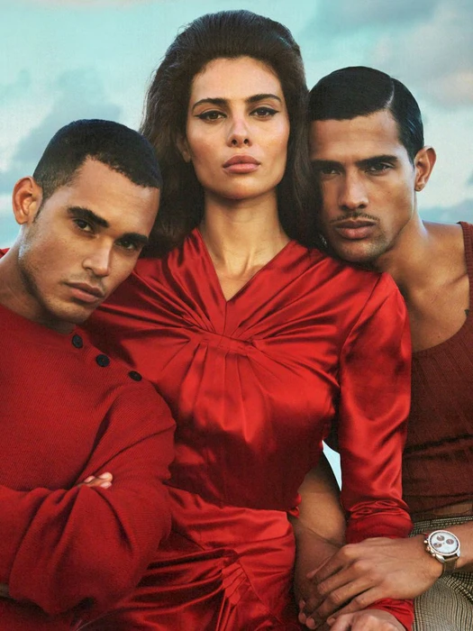 Three models posed together outdoors against an overcast sky for a fashion editorial published in V Magazine.