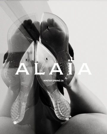 Artistic close-up of transparent women's shoes with 'Alaia Winter Spring 26' text overlay against a blurred, monochrome background.