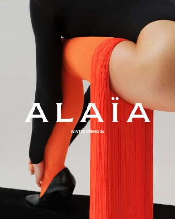Fashion editorial featuring a woman in orange tights, black leotard, and heeled shoes, set against a soft grey background. Text overlay.