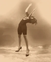 Model in dark athletic apparel and high heels arching backward against a sepia-toned backdrop by Paul Kooiker for Acne Paper.