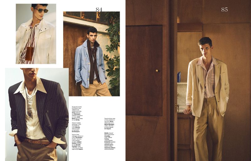 Fashion editorial featuring a young adult male model wearing light-colored, vintage-inspired clothing, photographed in a sunlit, indoor setting.