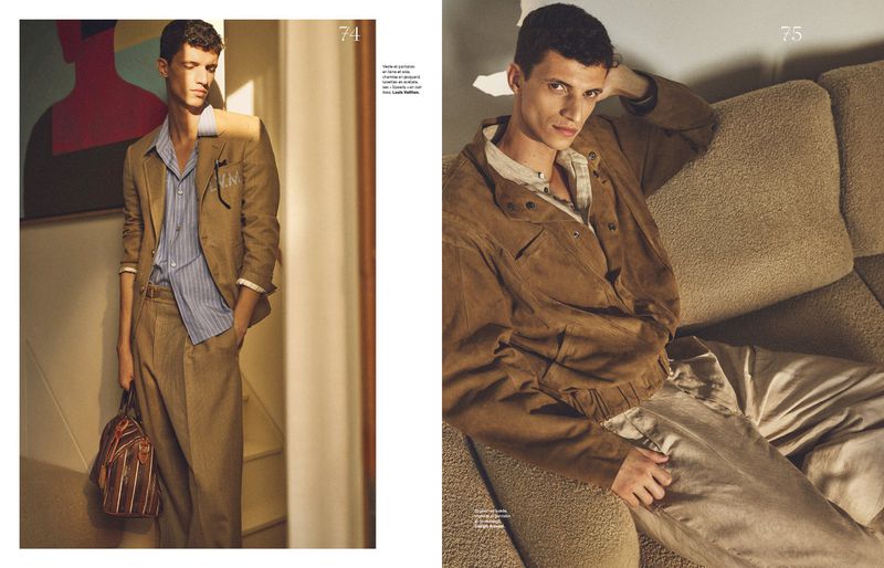 Editorial fashion shot of a young adult male model in a tan suit standing indoors with sunlight. Another photo shows the model lounging on a tan sofa.