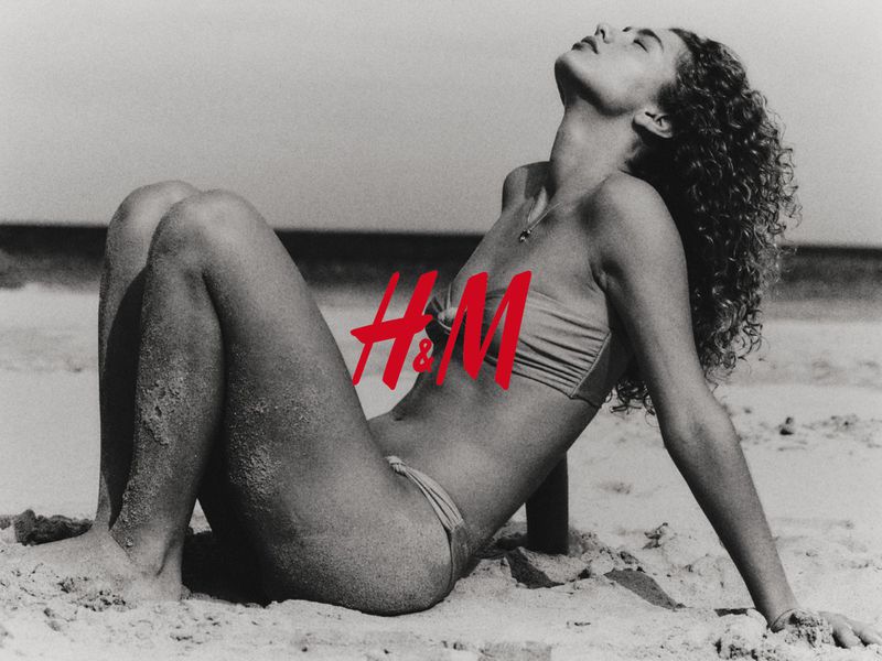 Model Dorit Revelis in a bikini posing on a sandy beach for H and M shot by David Portela