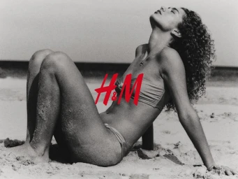 Model Dorit Revelis in a bikini posing on a sandy beach for H and M shot by David Portela