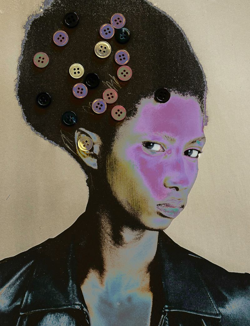 Artistic close-up of a woman's face with buttons affixed to her hair and face, creating a surreal, textural portrait on a neutral backdrop.