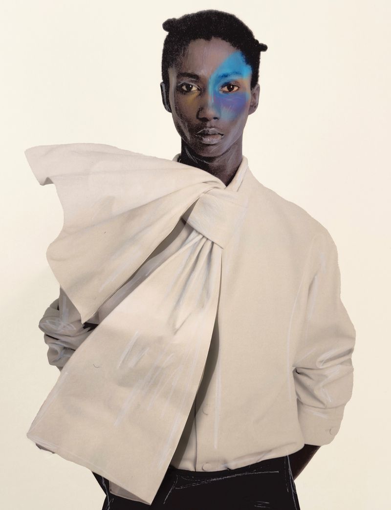 Fashionable person with blue face paint and unique hair, wearing a collared shirt with a large bow, against a neutral background.