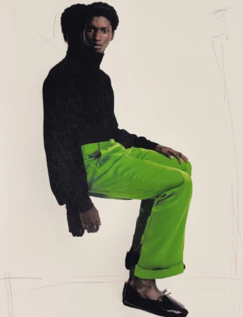 Model Douta Sidibe in a black turtleneck and green trousers against a light background for HERO Magazine