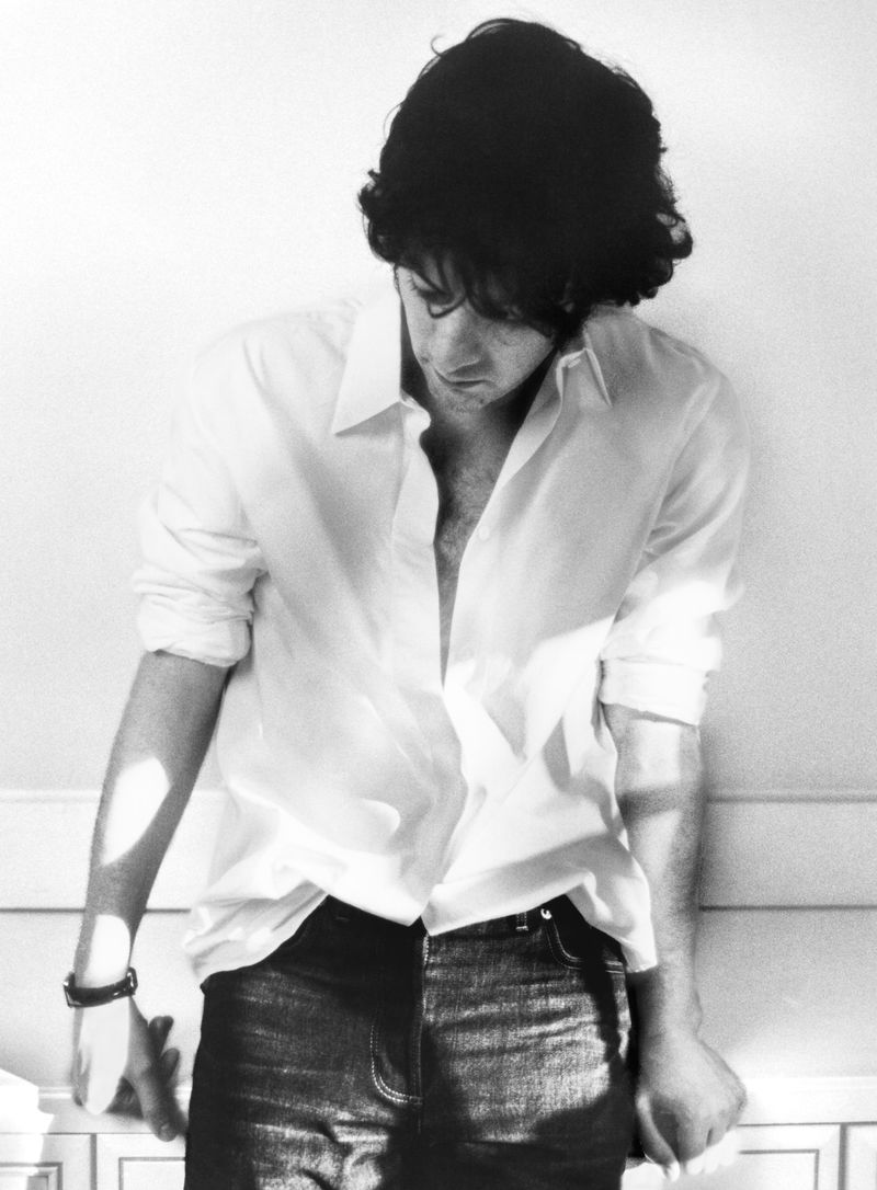 Dominic Sessa wearing a white button-down shirt and dark jeans in a monochrome portrait for HERO Magazine.