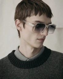 Model wearing translucent gradient sunglasses and a dark textured sweater for the Monochromatic project by Zalando