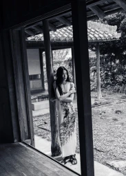 Model Kinari Tamukai leaning against a wooden pillar in a traditional building for Sasurai editorial by 5ELEVEN Magazine