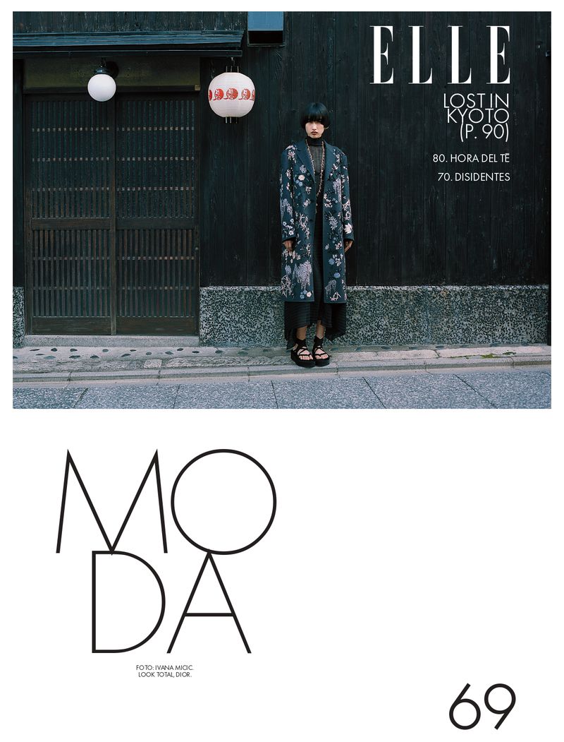 Fashion editorial cover of Elle magazine featuring a female model in a floral coat standing in front of a traditional Japanese building.