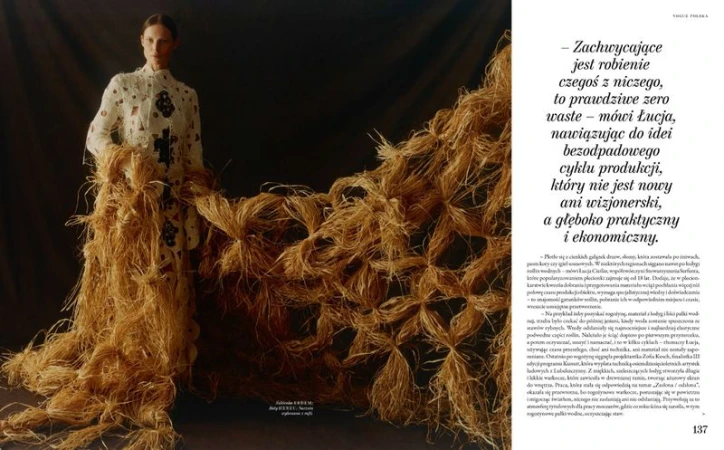 Model standing next to a large woven straw installation holding textured fabric for Vogue Polska editorial