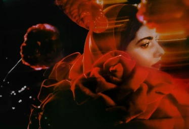 Portrait of Malala Yousafzai framed by large red roses and warm glowing light streaks for British GQ