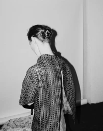 Model Eva Herzigova captured from behind wearing a patterned patterned top in a CAP 74024 editorial portrait