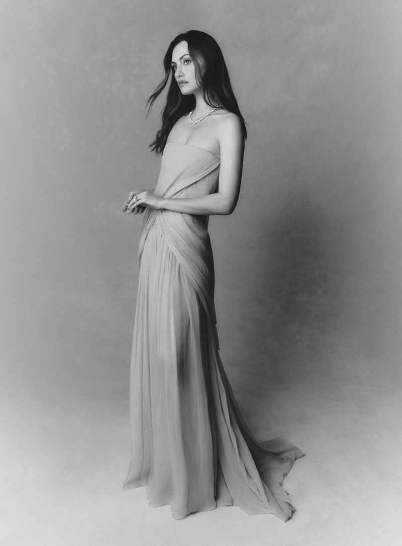 Phoebe Tonkin in a strapless draped gown posing against a grey studio backdrop for Vogue Australia