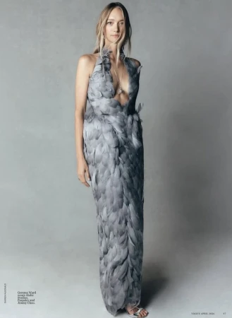 Gemma Ward wearing a feathered grey halter dress in a fashion portrait for Vogue Australia.