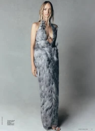 Gemma Ward wearing a feathered grey halter dress in a fashion portrait for Vogue Australia.