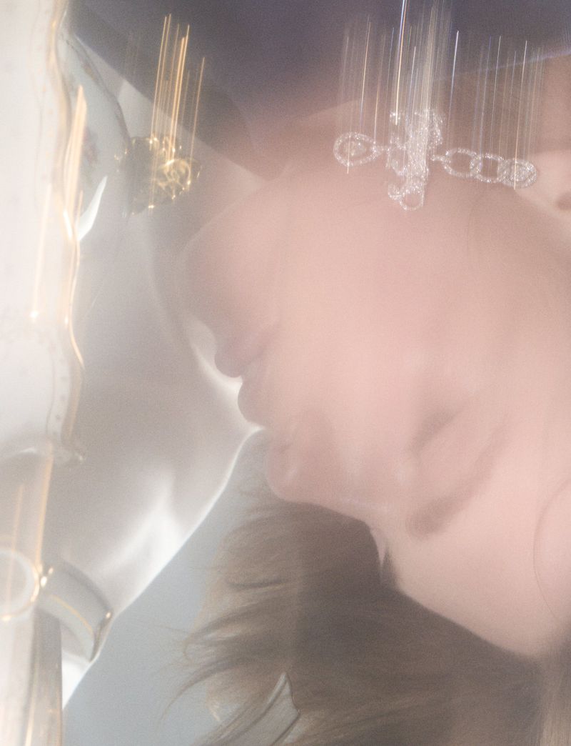 Close-up portrait of a model with motion blur wearing dangling crystal earrings for Pop Magazine.
