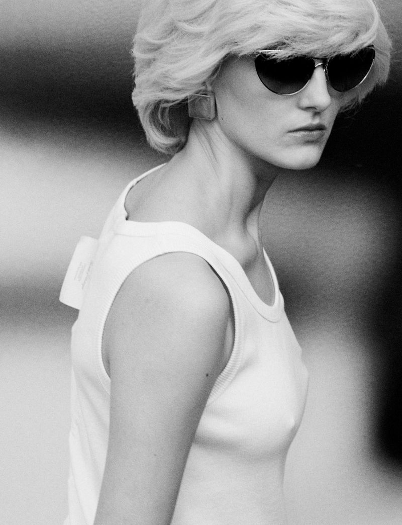 Model wearing dark sunglasses and a white tank top for Pop Magazine by Charlotte Stouvenot