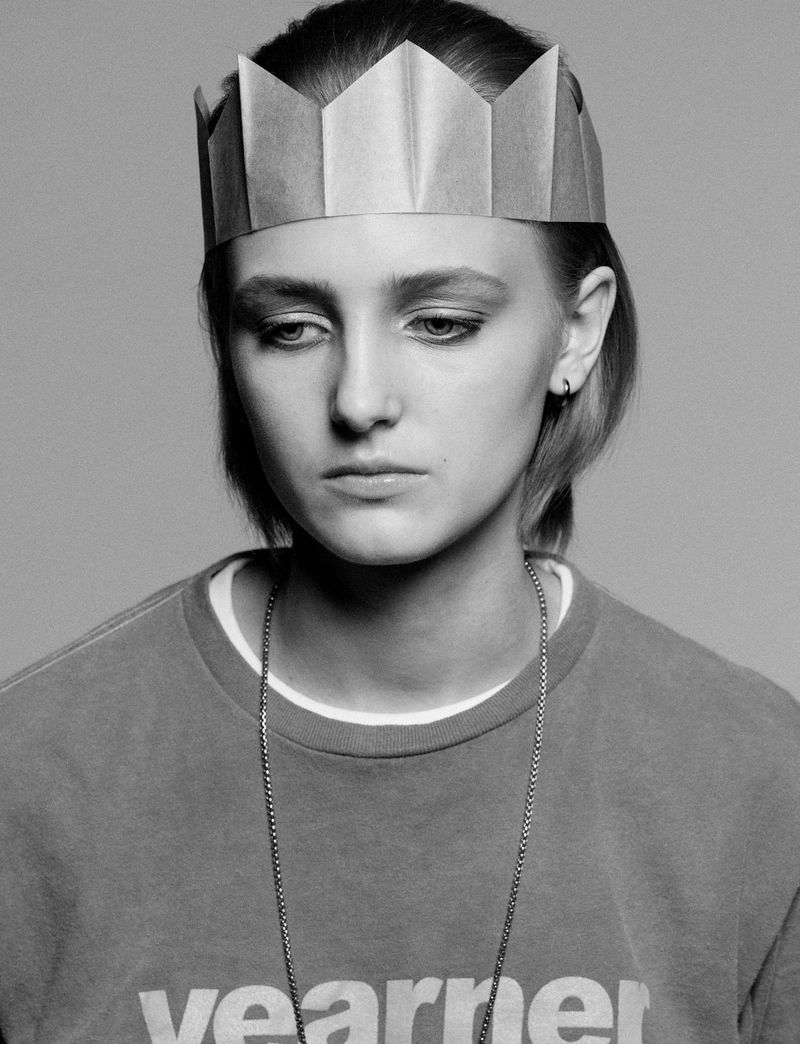 Model George Anderson wearing a paper crown and sweatshirt for Pop Magazine, photographed by Charlotte Stouvenot