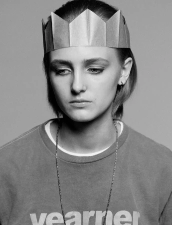 Model George Anderson wearing a paper crown and sweatshirt for Pop Magazine, photographed by Charlotte Stouvenot