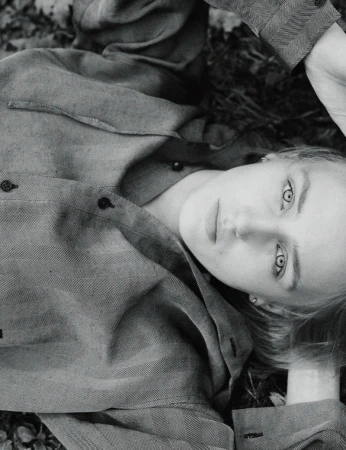 Model George Anderson lying on woodland ground wearing patterned long-sleeve shirt in Pop Magazine editorial by Charlotte Stouvenot.