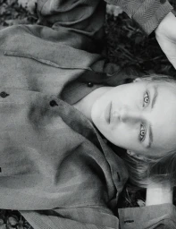 Model George Anderson lying on woodland ground wearing patterned long-sleeve shirt in Pop Magazine editorial by Charlotte Stouvenot.