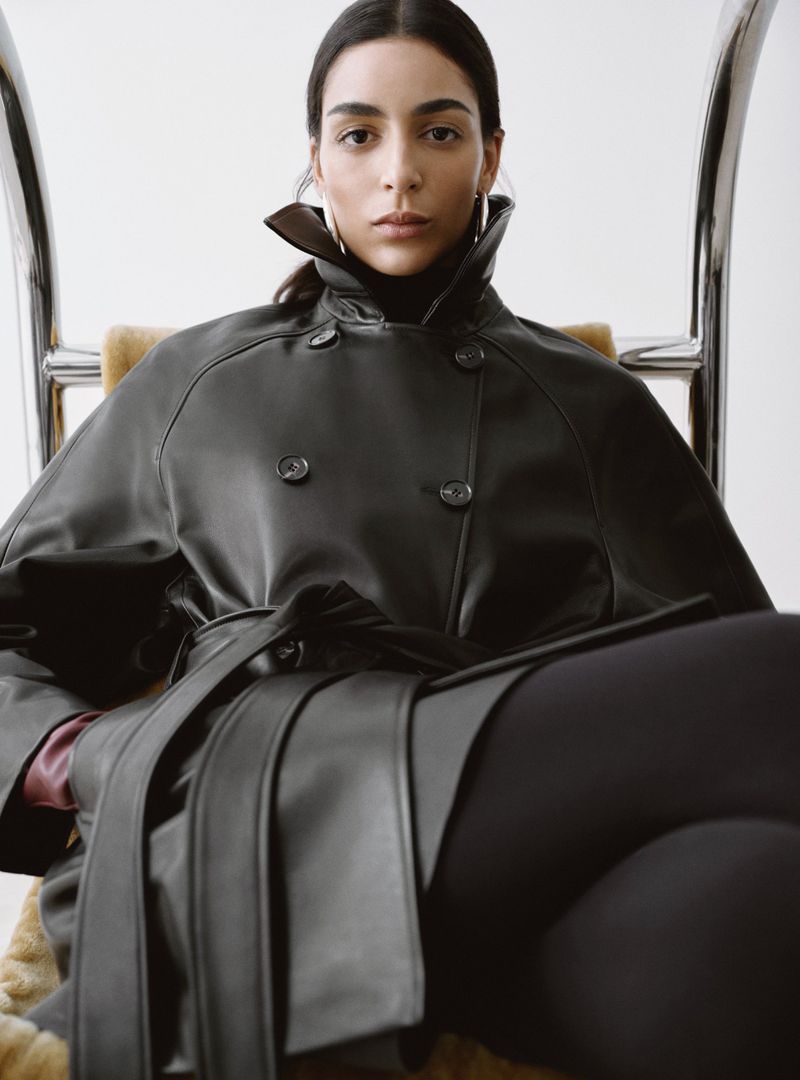 Model Nora Attal seated wearing a black leather coat and turtleneck for Nour Hammour Spring Summer 26.