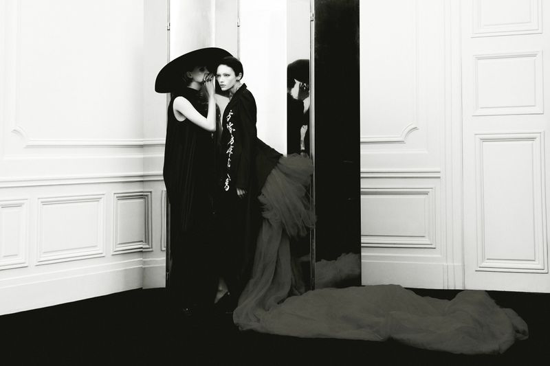 Two models in black outfits posing indoors against white paneled walls for Beyond Noise Issue 5 photography by Robin Galiegue.