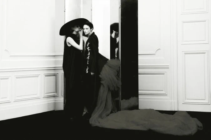 Two models in black outfits posing indoors against white paneled walls for Beyond Noise Issue 5 photography by Robin Galiegue.