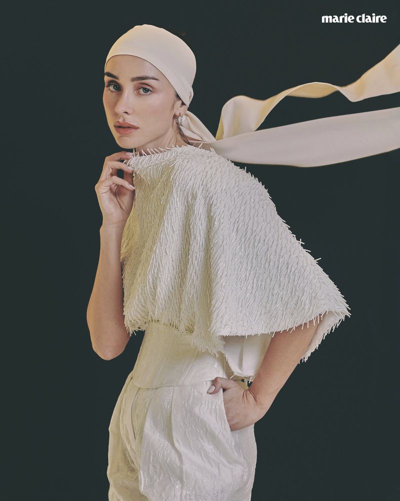 Woman wearing a textured white fringed top and headscarf against a dark background for Marie Claire Mexico.