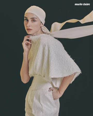 Woman wearing a textured white fringed top and headscarf against a dark background for Marie Claire Mexico.