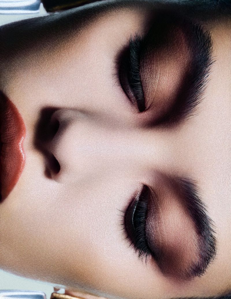Close-up beauty portrait of a model with dramatic eye makeup and dark lashes, photographed by Kevin Rinaldo.