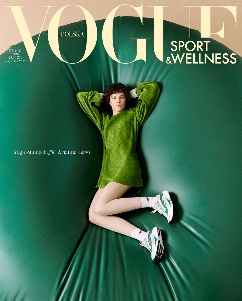 Model with curly hair in green dress and sneakers lying on puffed green backdrop for Vogue magazine cover