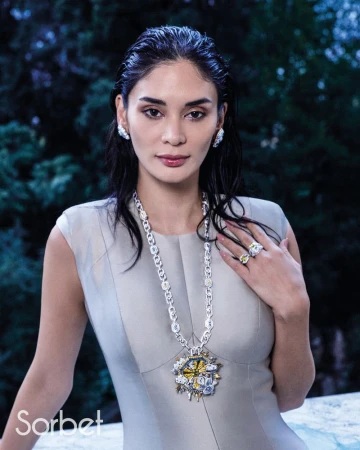 Woman wearing a grey dress and diamond pendant necklace in Sorbet Magazine editorial for Pia Jauncey