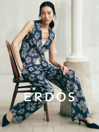 Model Liu Wen wearing a blue floral vest and matching trousers seated on a wooden chair for Erdos