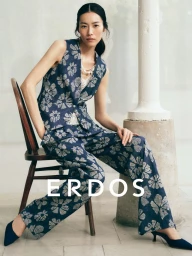 Model Liu Wen wearing a blue floral vest and matching trousers seated on a wooden chair for Erdos