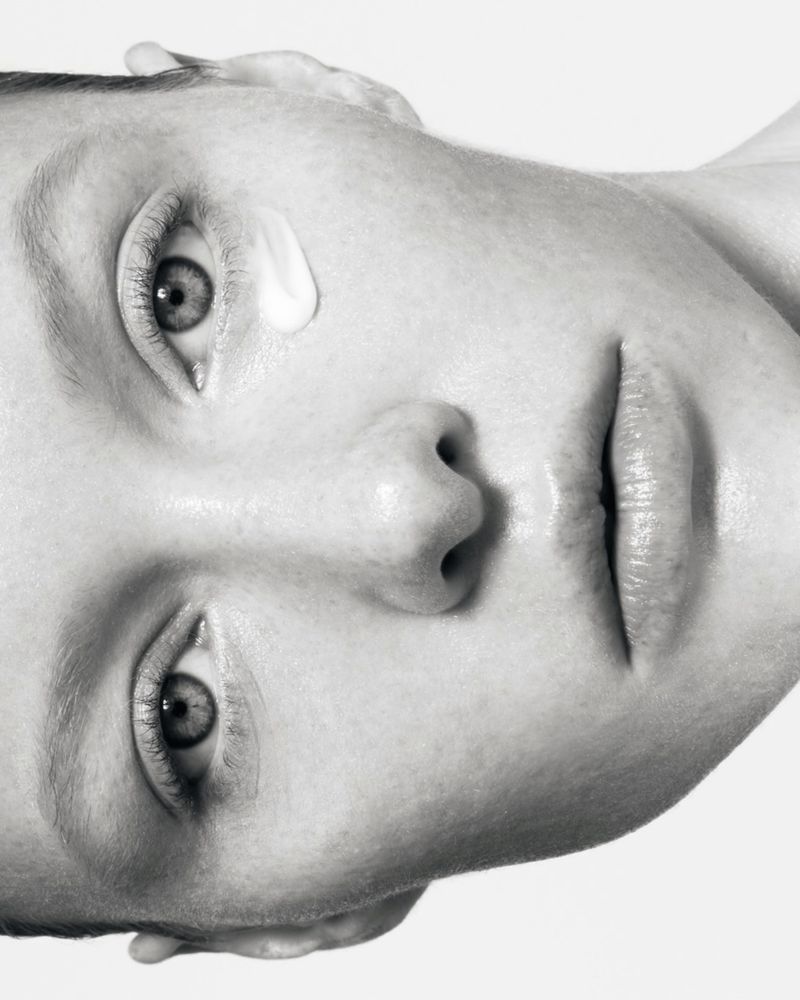 Close-up monochrome portrait of a model with skincare cream near her eye for Instytutum shot by Serhii Vasyliev.