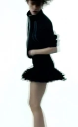 Model in motion wearing a dark jacket and skirt against a bright white background for Sandro