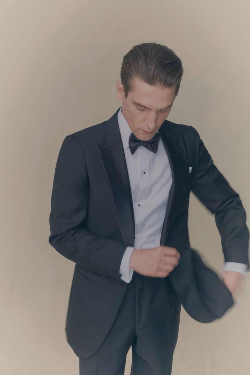 Man wearing a black tuxedo with white shirt and bow tie against a neutral background for Eton of Sweden