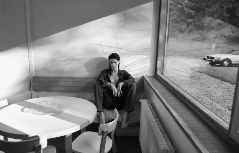 Model Isabeli Fontana seated indoors near a large window for Matteau Summer 2026 campaign photographed by Chris Colls