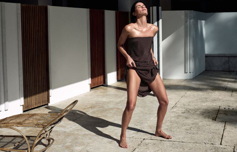 Model Isabeli Fontana wearing a polka dot dress outdoors in bright sunlight for Matteau Summer 2026