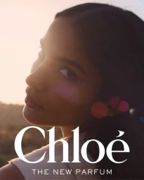 Close-up portrait of a model looking back over her shoulder with warm sunset lighting and Chloé branding text