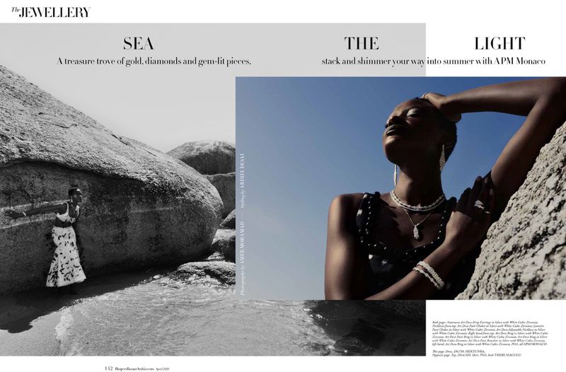Editorial spread for Harper's Bazaar Arabia featuring a black woman wearing APM Monaco jewelry against rocky coast and blue sky