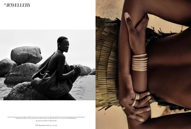 Black and white editorial magazine spread featuring a model posing near rocky coastal waters and stacked jeweled bracelets.