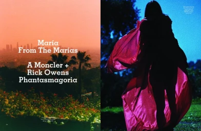 Spreading pink cape worn by silhouetted figure standing outdoors at dusk with city skyline in distance