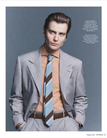 Model Ben Allen wearing a grey suit, peach shirt, and striped tie for Monsieur Magazin Germany