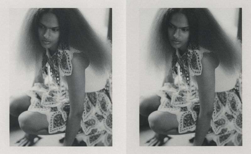 Model with voluminous hair crouching in patterned lace skirt for Manifesto Magazine
