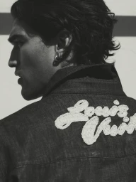 Close-up profile of Josh Heuston wearing a dark denim jacket with embroidered white lettering for Esquire Australia.